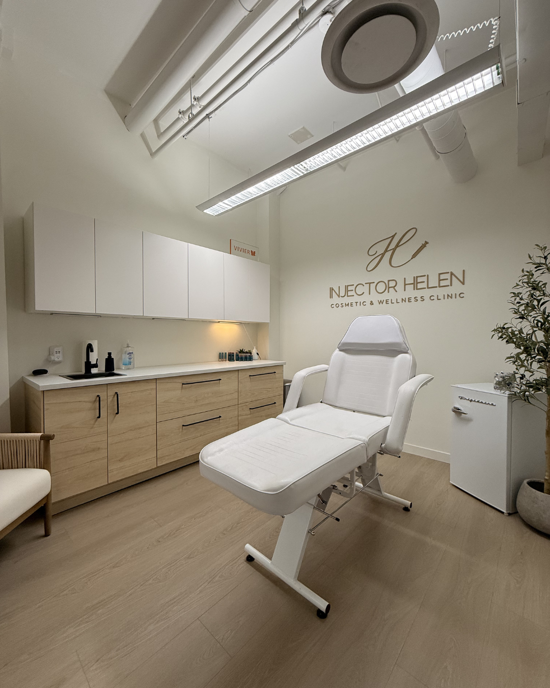 Interior of a treatment room at The Beauty Social with a treatment chair and cabinetry