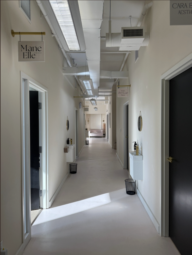 Bright hallway with private salon suite doors at The Beauty Social